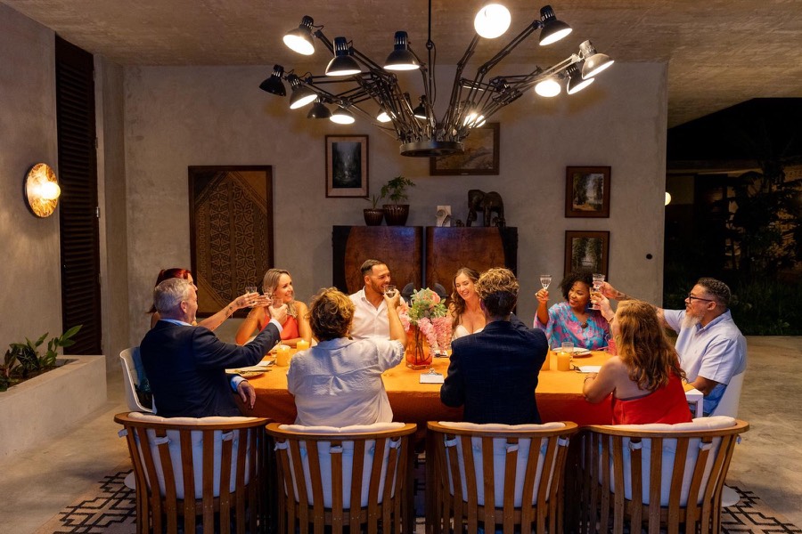 Guests raising a toast around a private dinner table