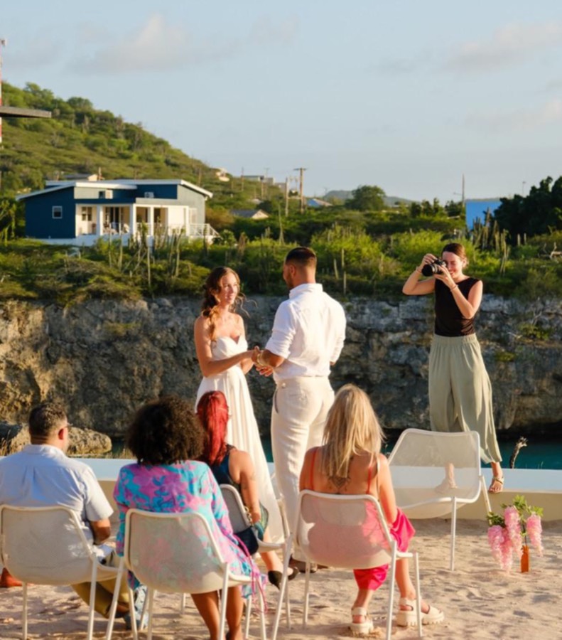 Wedding ceremony on the beach in Curaçao with guests looking on