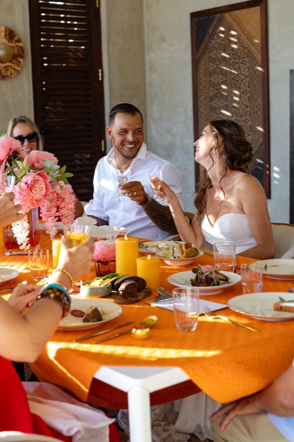 Bride and groom raising a toast at a wedding brunch