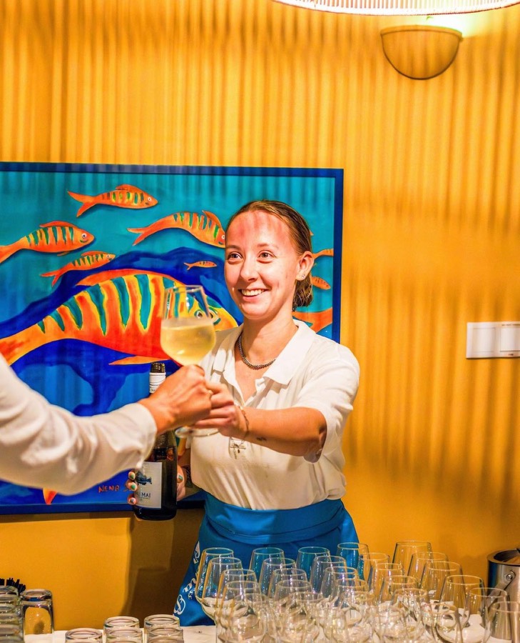 Sommelier Jeandine serving a glass of wine at an event
