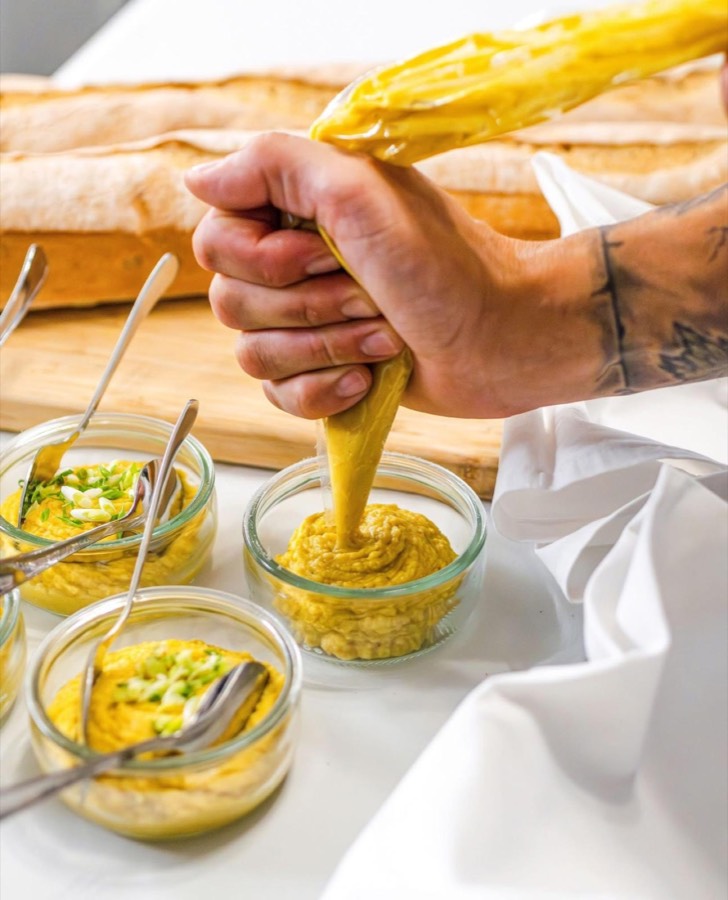 Piping a filling for canapés at an event